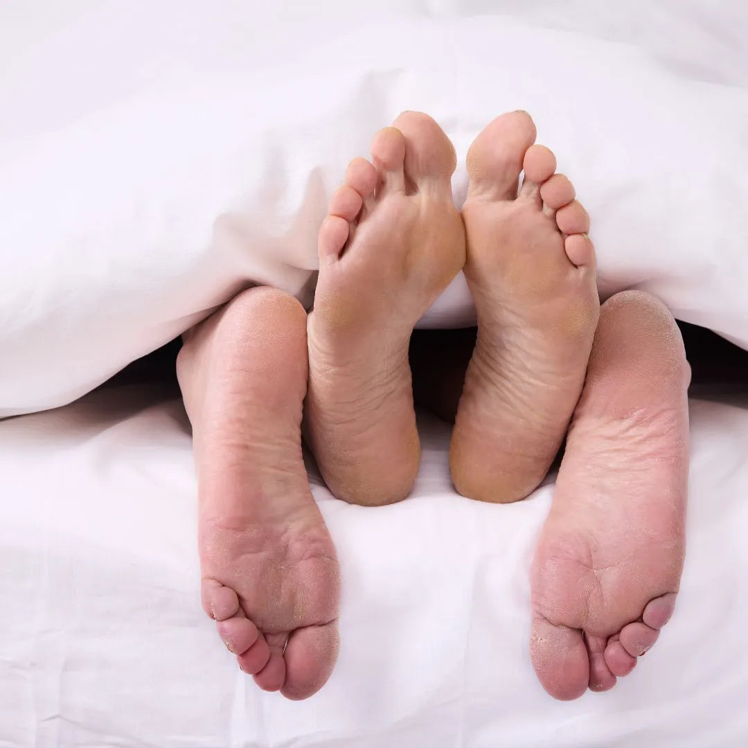 close up of feet in bed