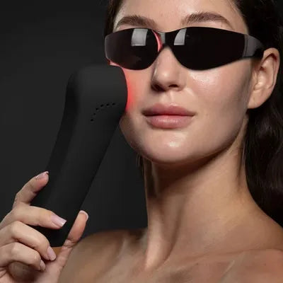 woman with goggles on with led device to her cheek