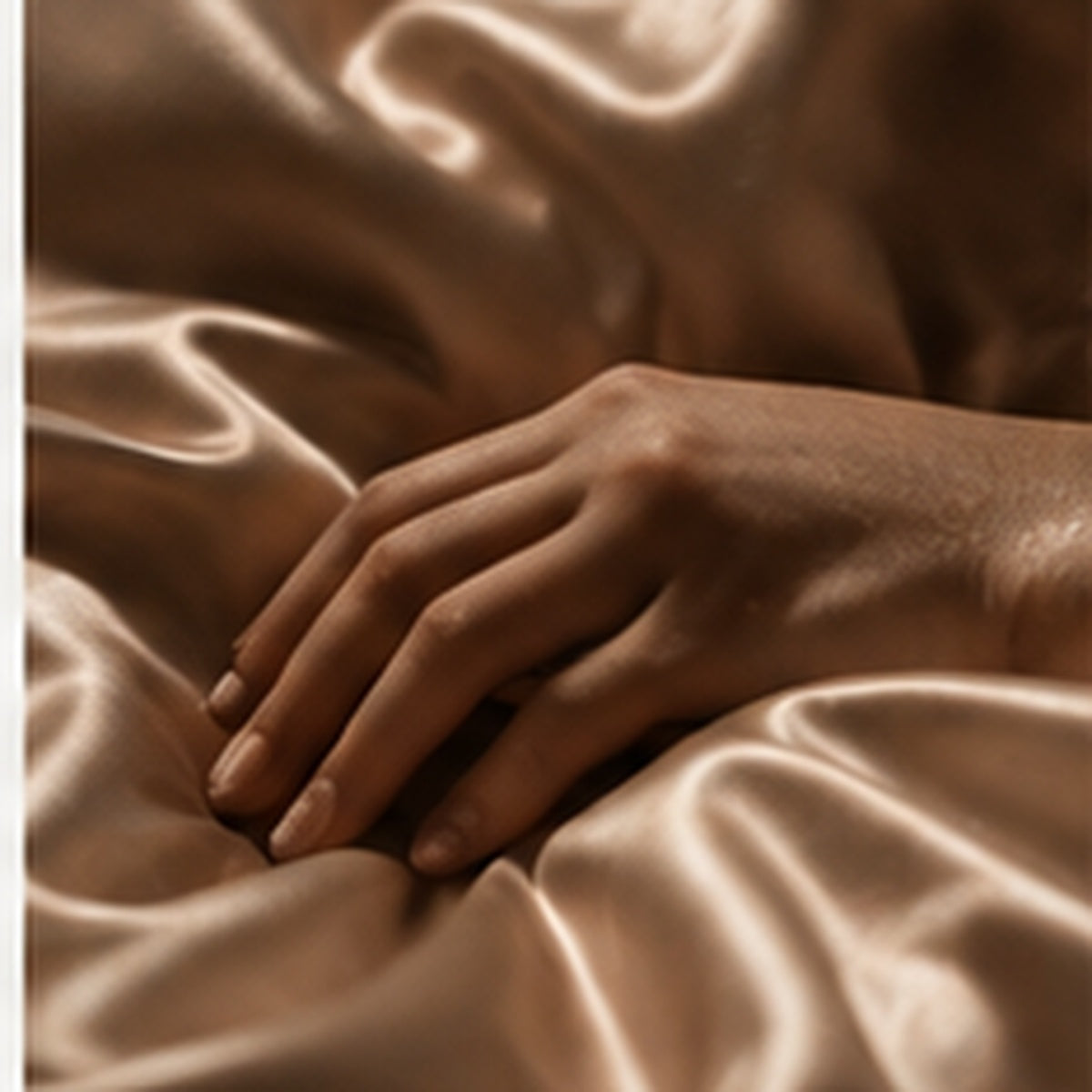 hand on satin sheets