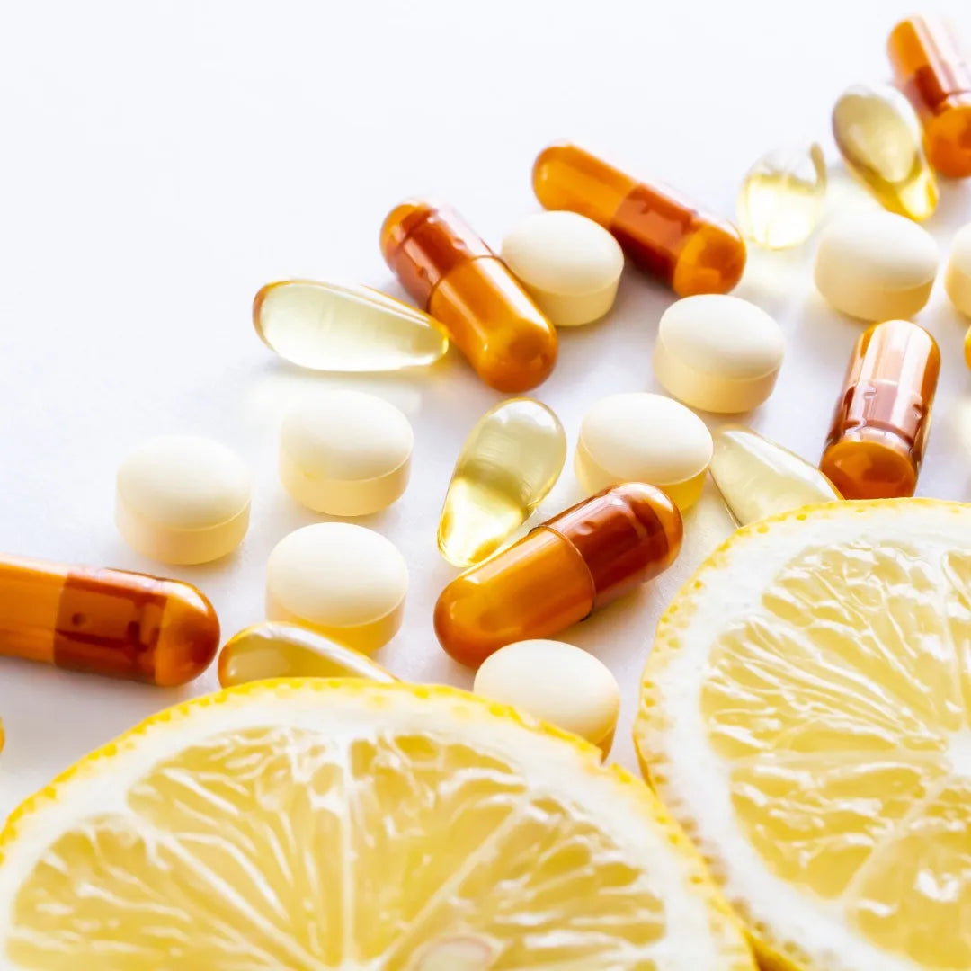 close up of vitamins and sliced lemons