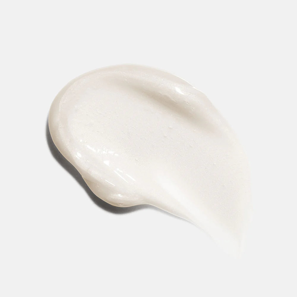 Close-up of a smooth, beige cream on a light gray background