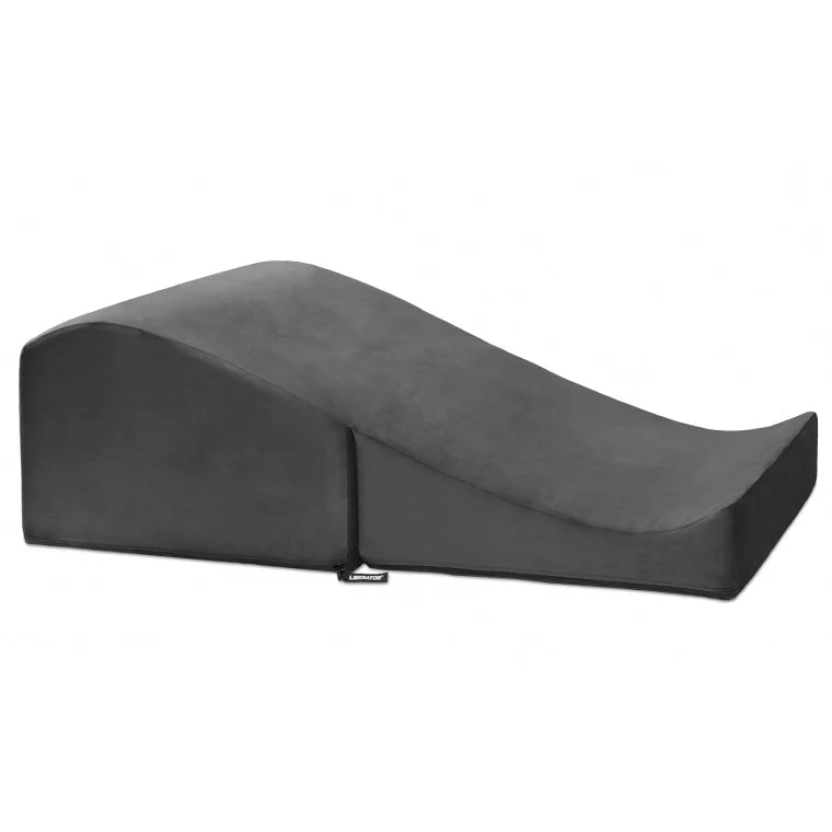 A dark gray contoured wedge pillow, shown on a solid white background.