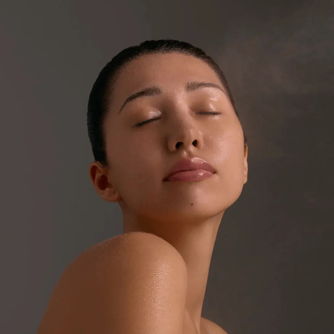 Person with damp face after using Young Goose Blue Peptide Spray