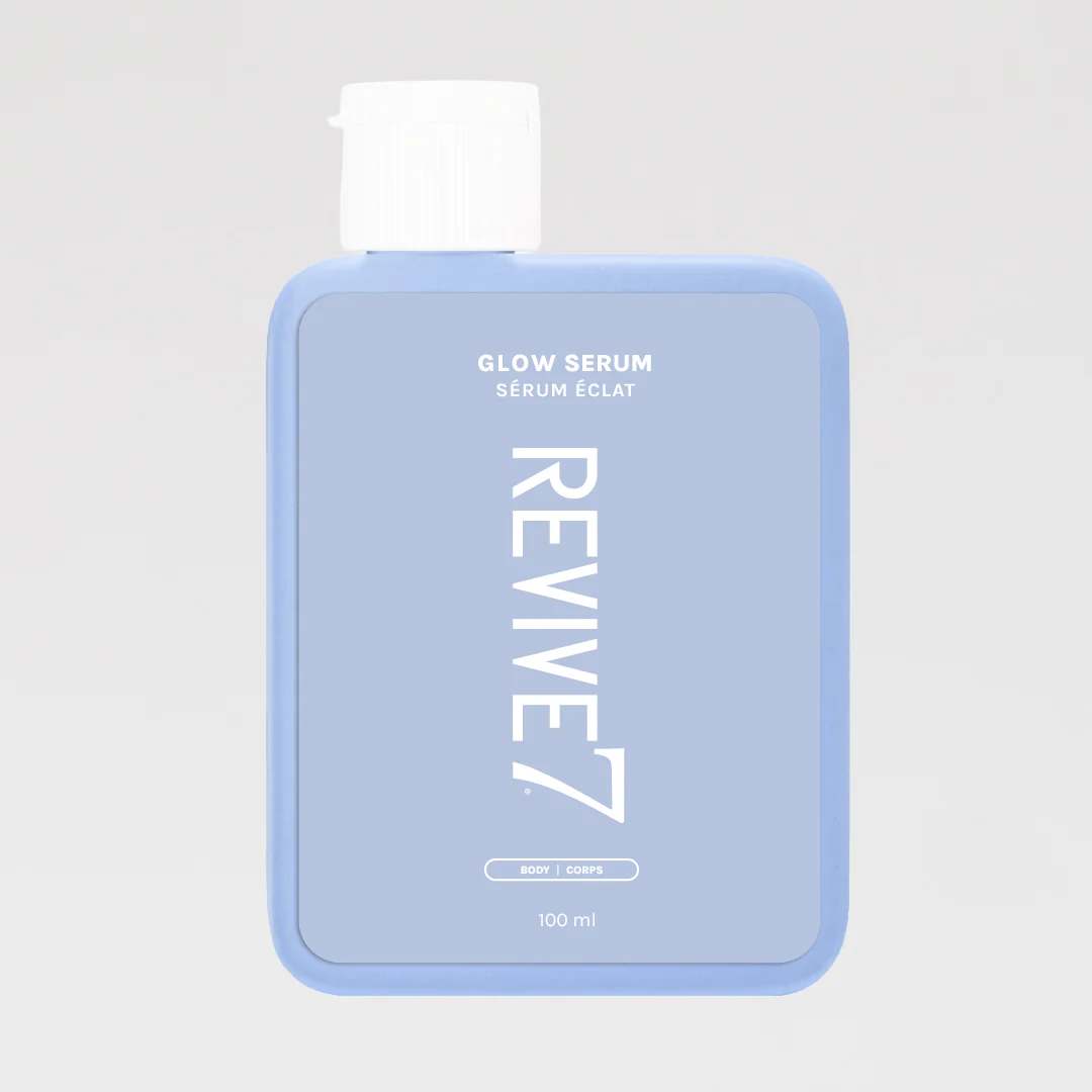 Blue bottle of Revive7 Glow Serum on a light gray background