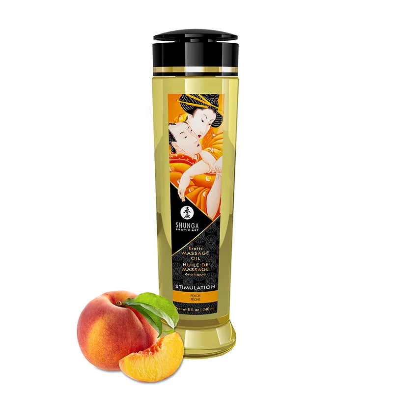 Bottle of Shunga massage oil with a peach and green leaf on a white background