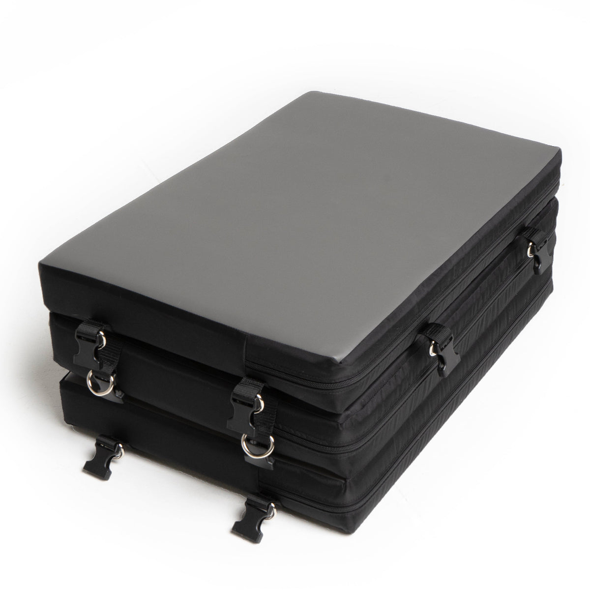 Stack of black rectangular cases with zippers on a white background