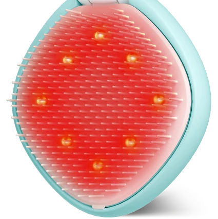 A handheld scalp massager with a light blue outer frame, white silicone bristles, and built-in LED light therapy pads glowing red on a white background.