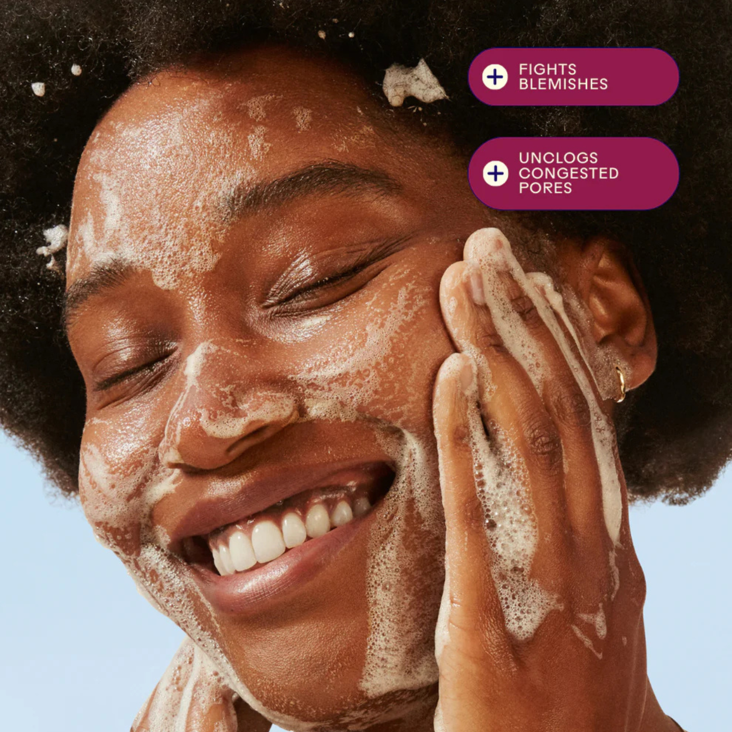 Person lathering bubbles on her face