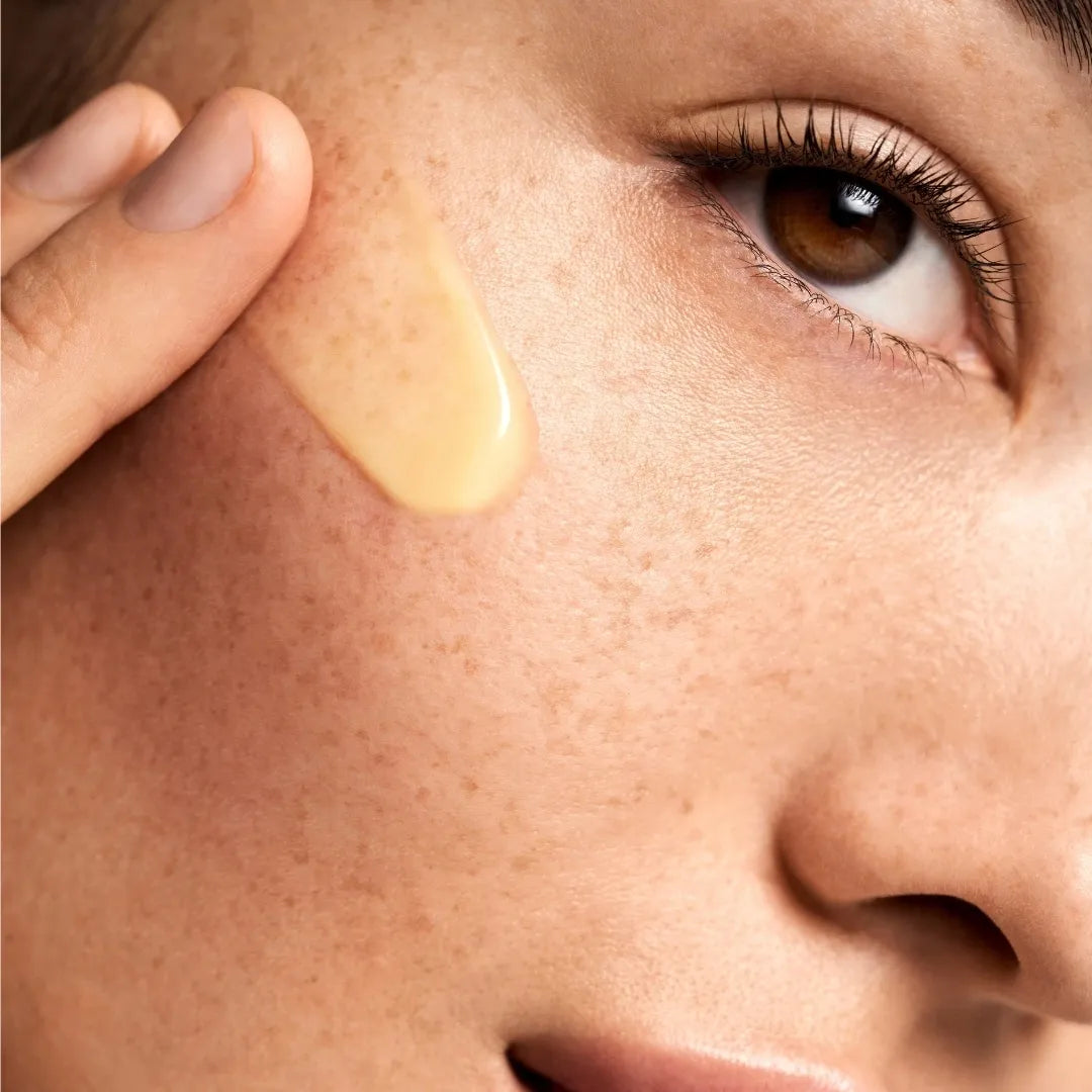 close up of person's face with a serum swatch