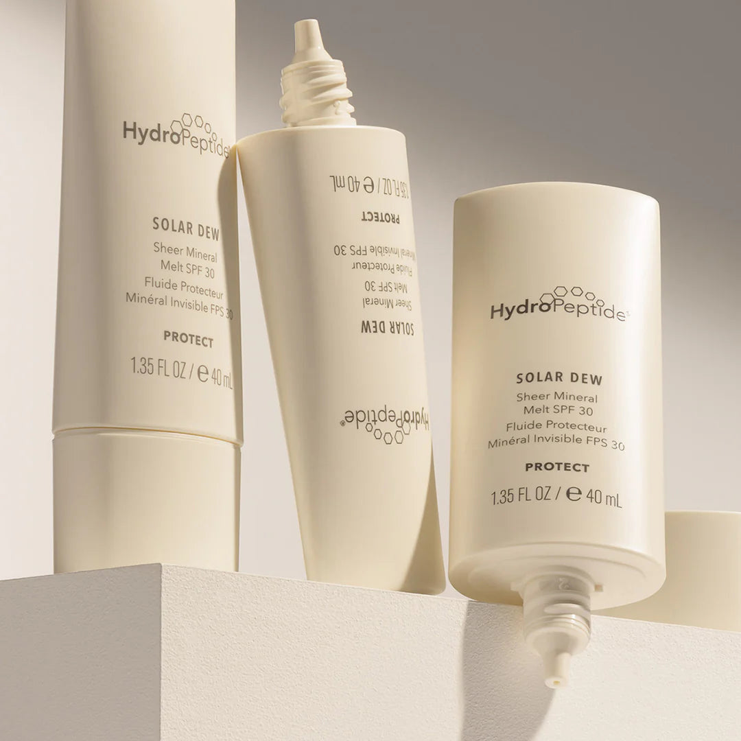Three HydroPeptide skincare products on a neutral background