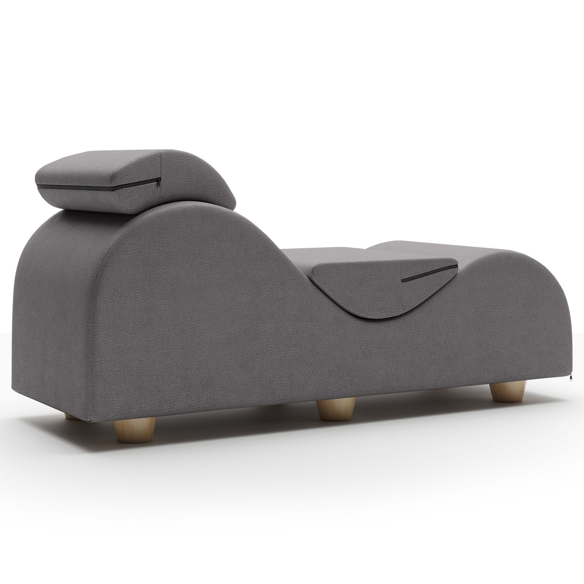 A modern gray upholstered chaise lounge chair with a padded headrest and small wooden legs, shown on a clean white background.