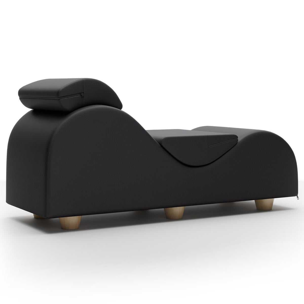 A modern black massage chaise lounge with a curved backrest, built on a low base with light wood legs, shown against a plain white background.