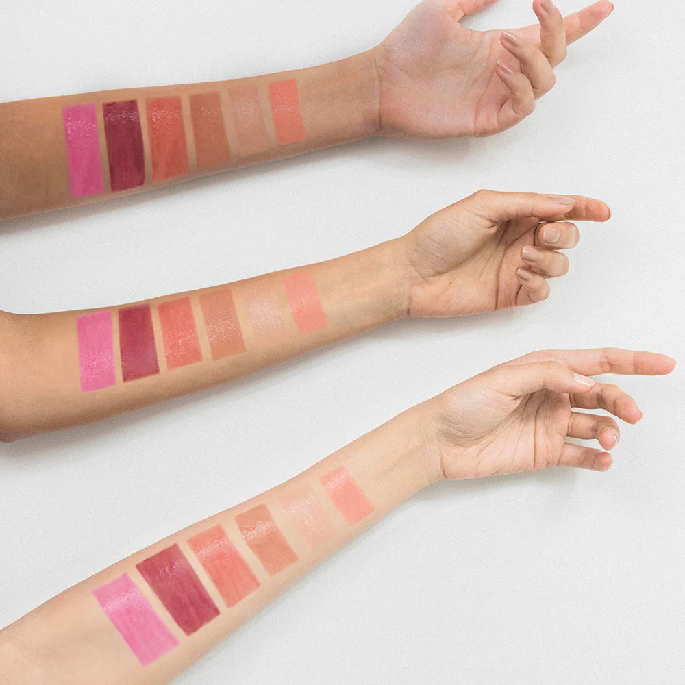Lipstick swatches on a person's arm with a white background