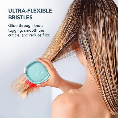Woman brushing her hair with FOREO LED brush