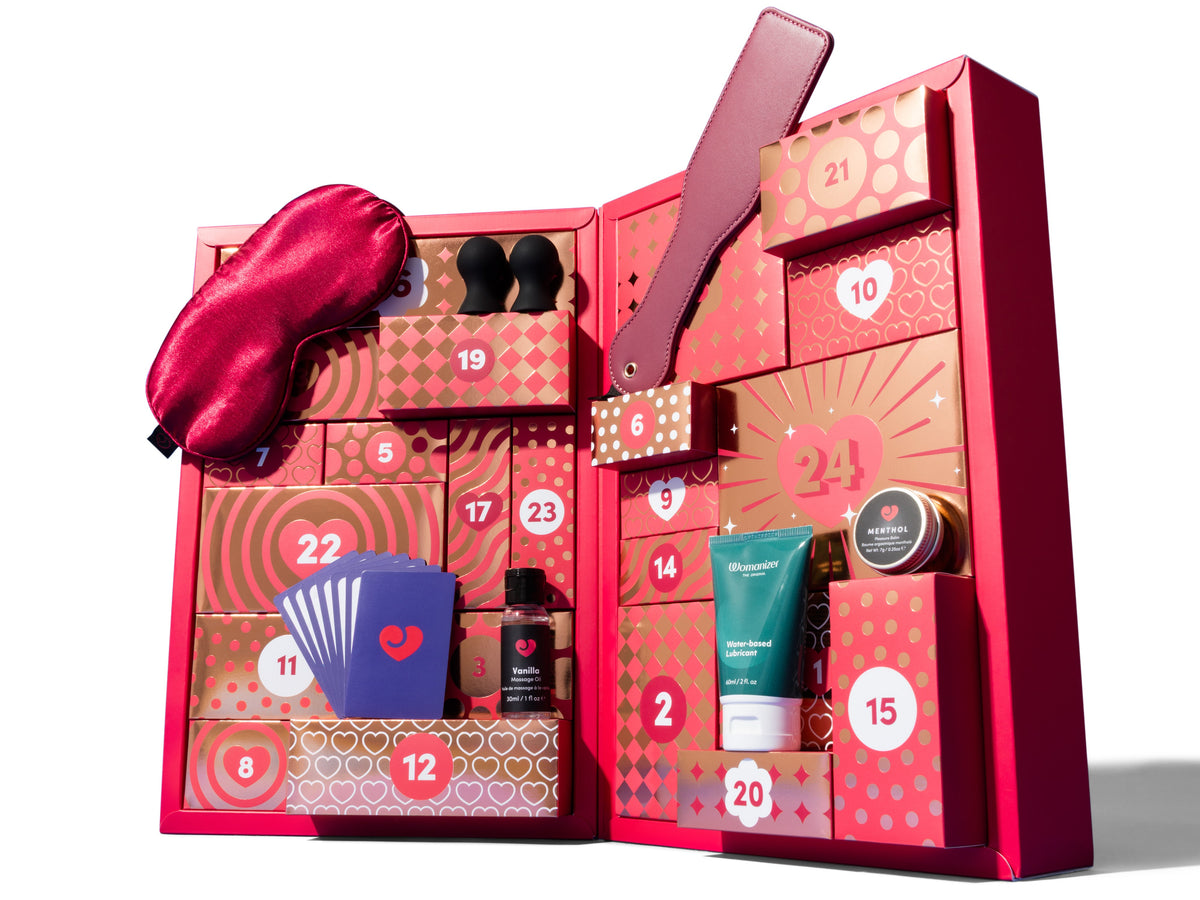 photo of red advent calendar with a few sex toys on white background