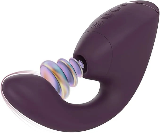 A purple curved personal massager with a textured, ribbed head and a small iridescent ring detail, shown against a plain white background.