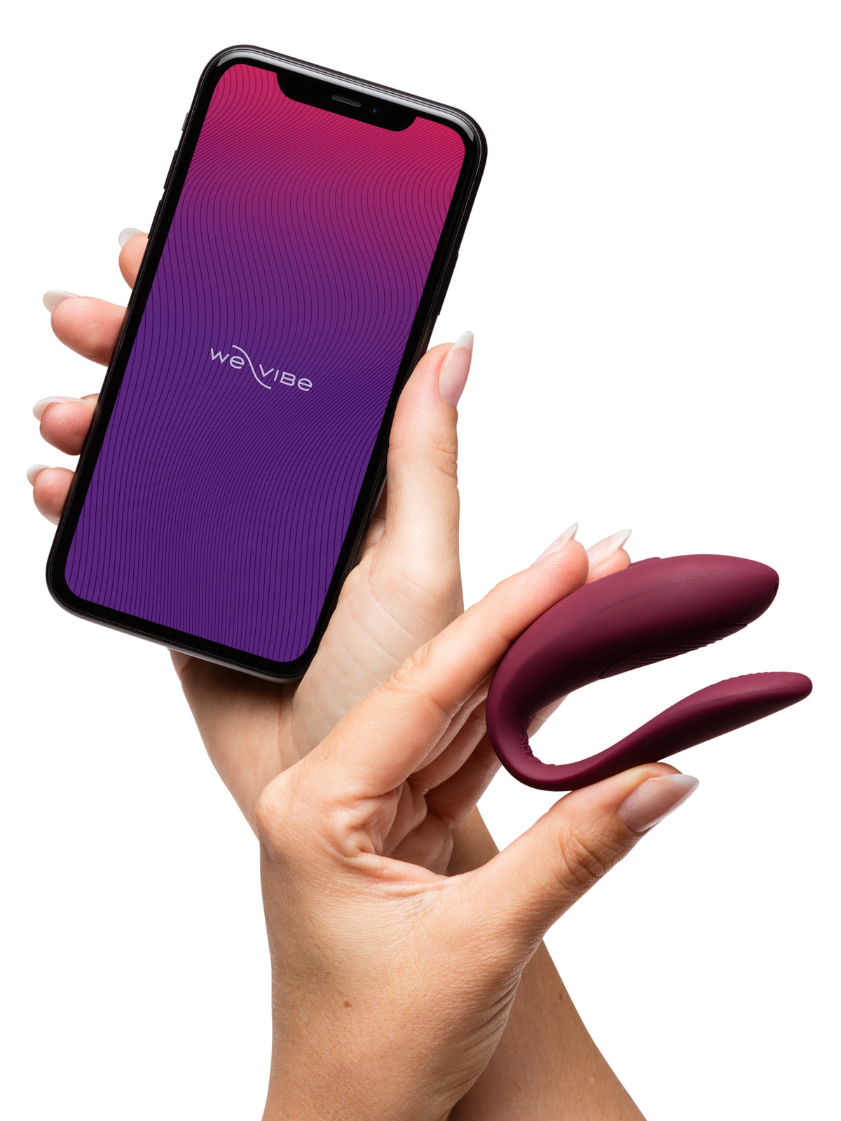 close up of hand holding a silicone massager and iphone with we-vibe app