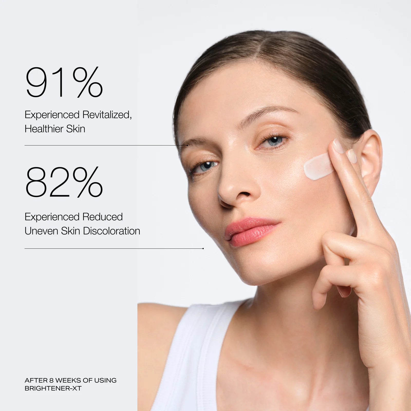 Woman applying skincare product with text on revitalized skin and reduced uneven skin discolouration.