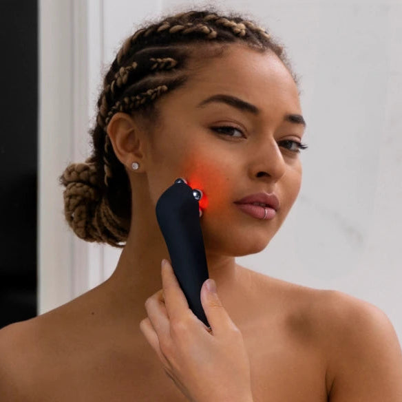 Person holding up device to her cheek