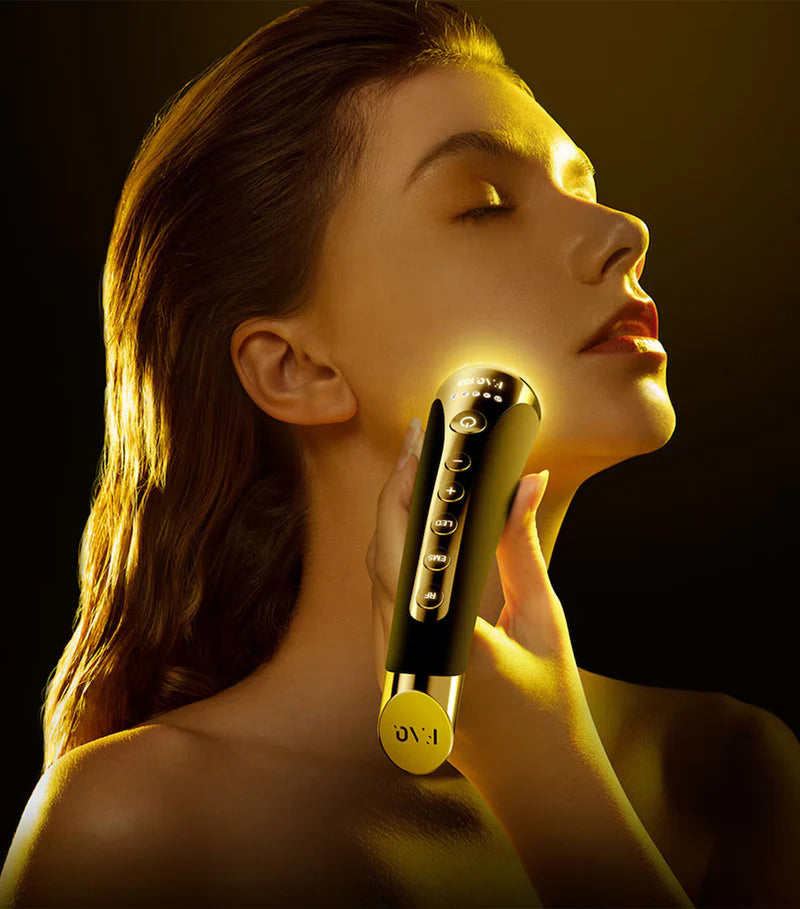 Woman using a skincare device on her face with a dark background