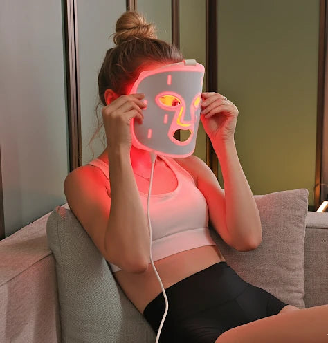 woman wearing red light therapy mask