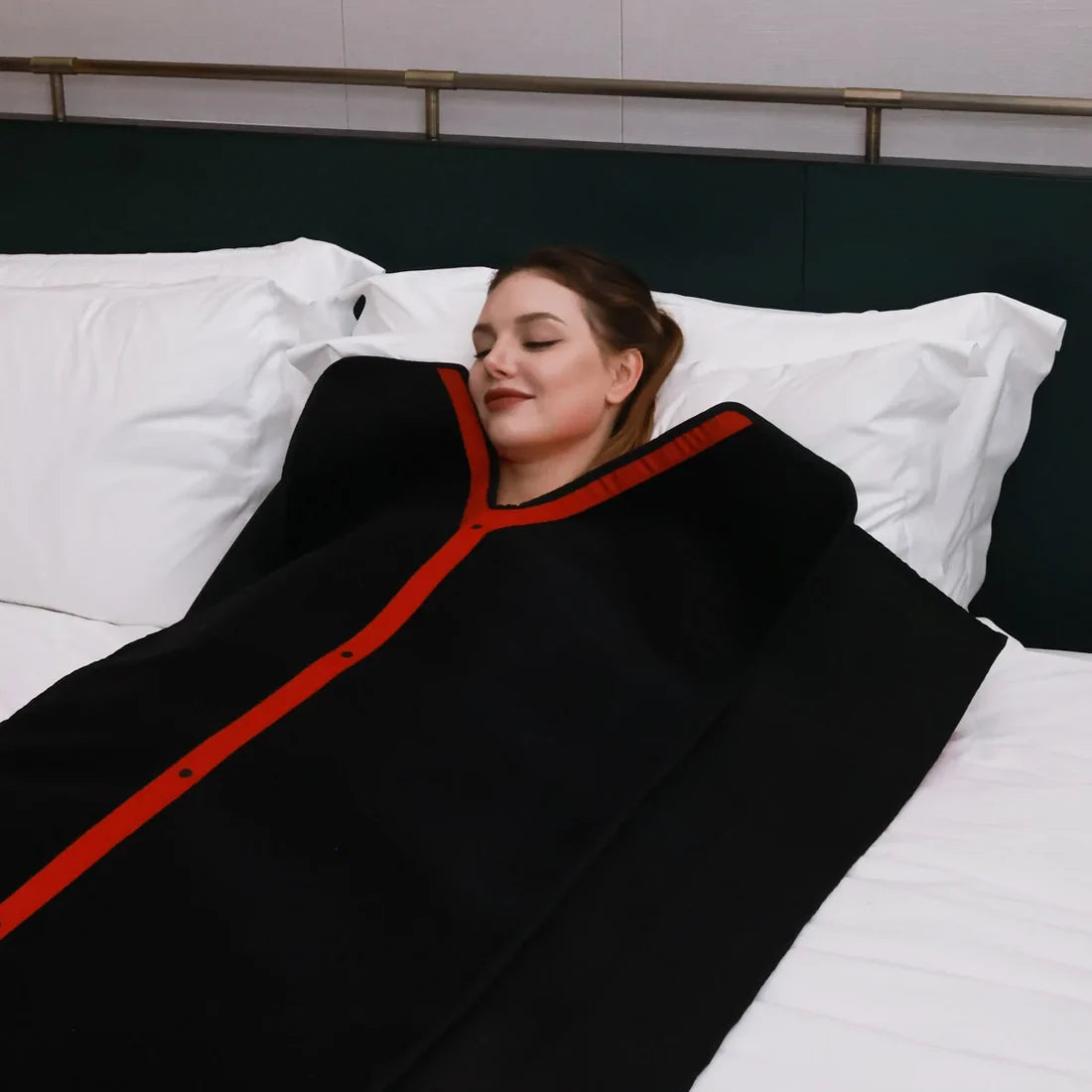woman zipped up in red light blanket