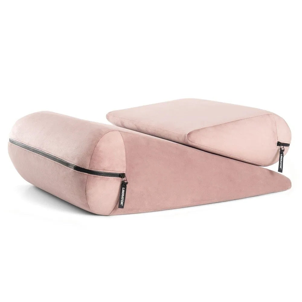 Pink wedge-shaped cushion with zippers on a white background