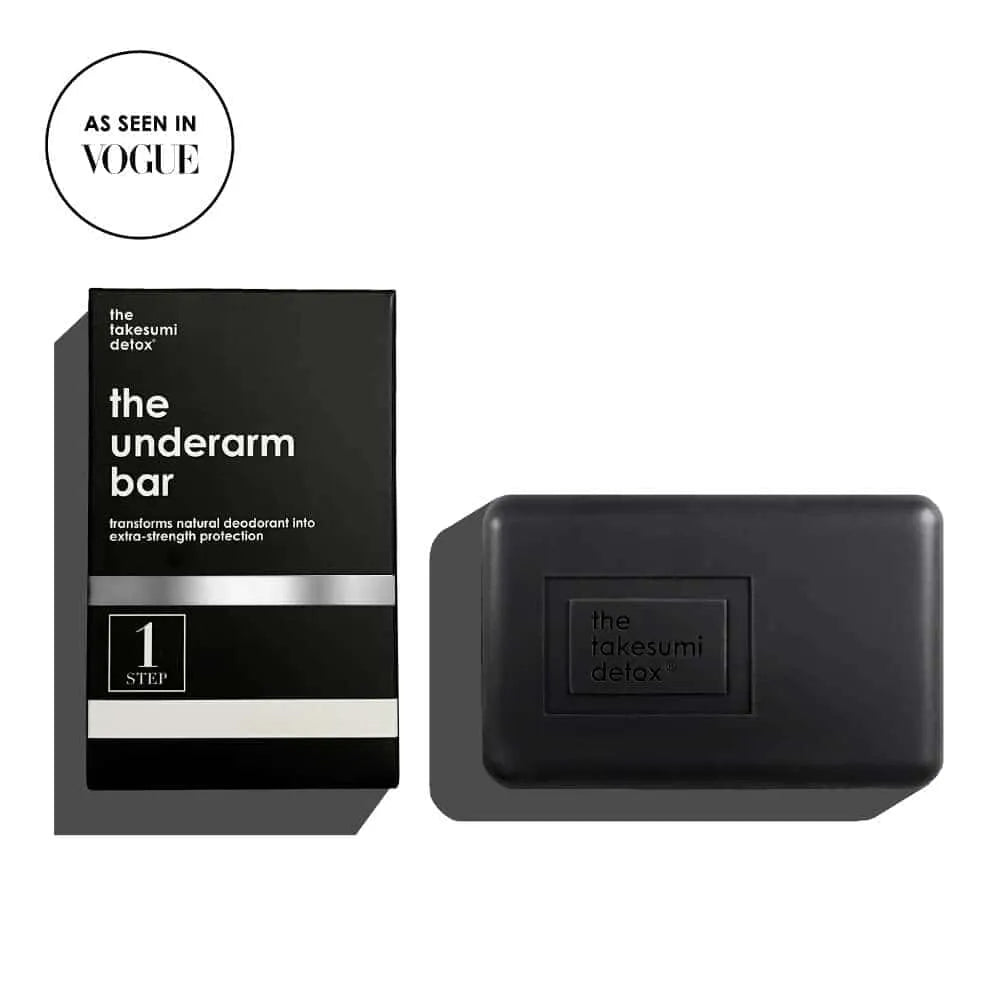 Black soap bar and packaging labeled 'the takesumi detox' on a white background.