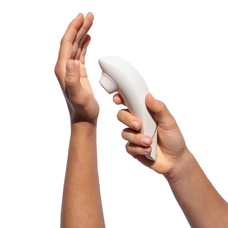 White handheld device held by two hands against a white background