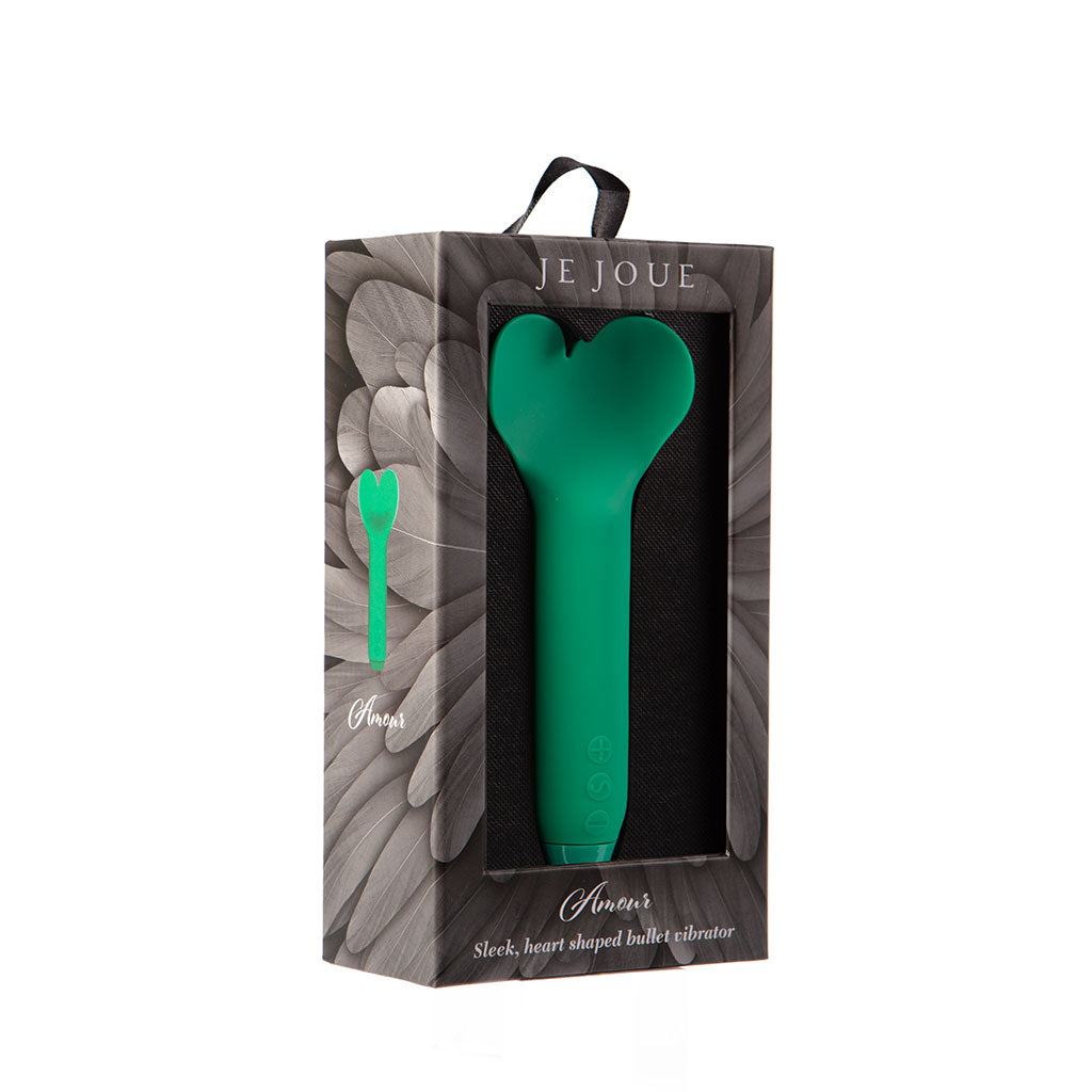 Green heart-shaped bullet vibrator in packaging with 'JE JOUE' branding on a white background