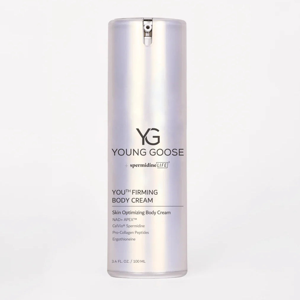 A silver cylindrical bottle of Young Goose Spermidine Youth Firming Body Cream on a light gray background.
