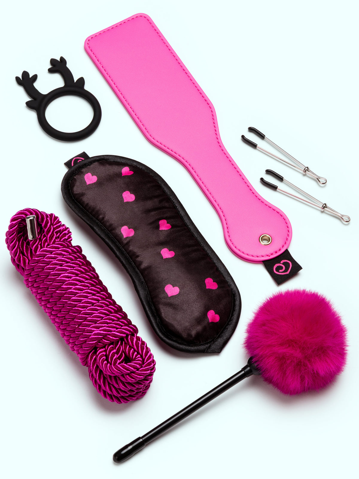 pink accessories, such as paddle, fluff and blindfold