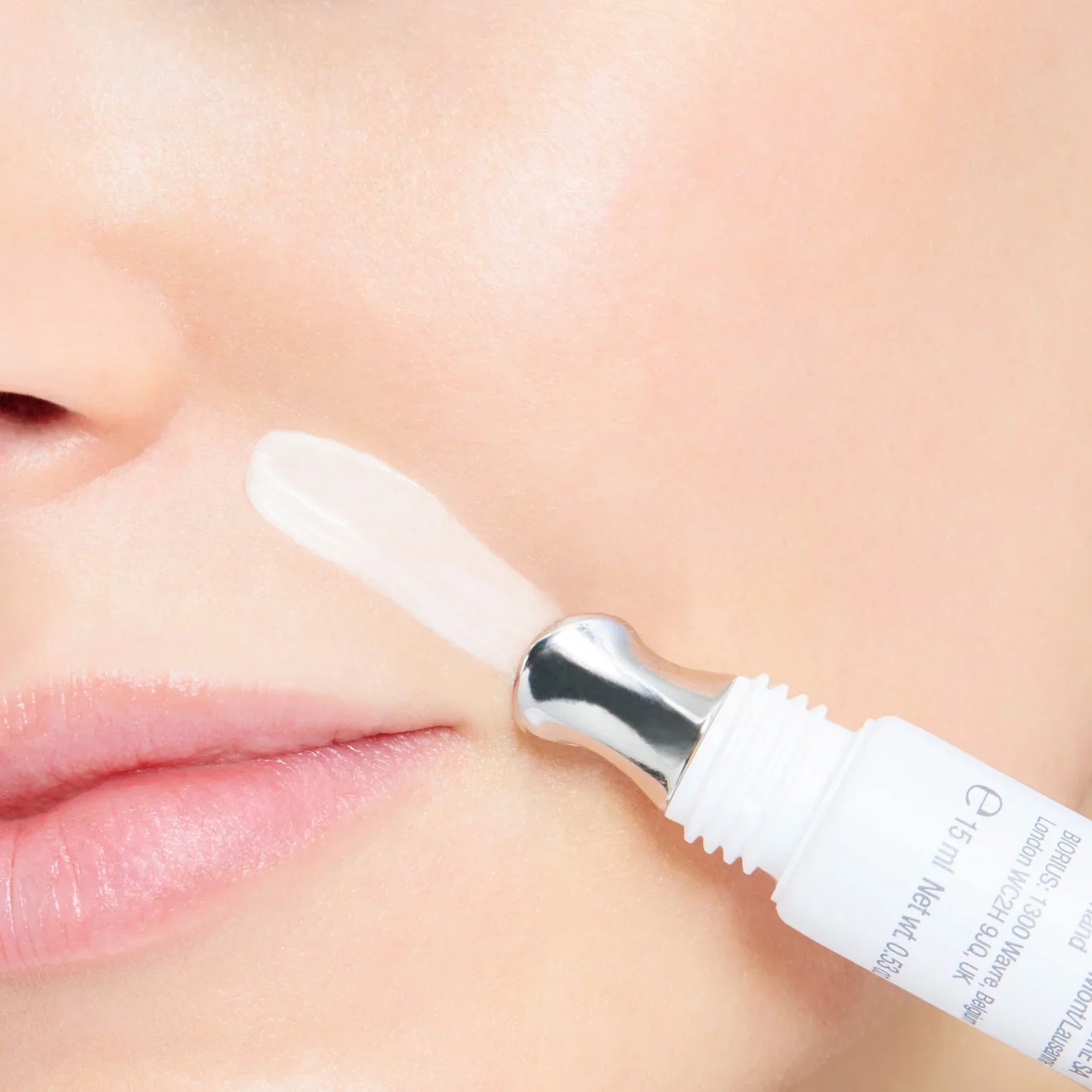 cream being applied to lip lines with a close-up view