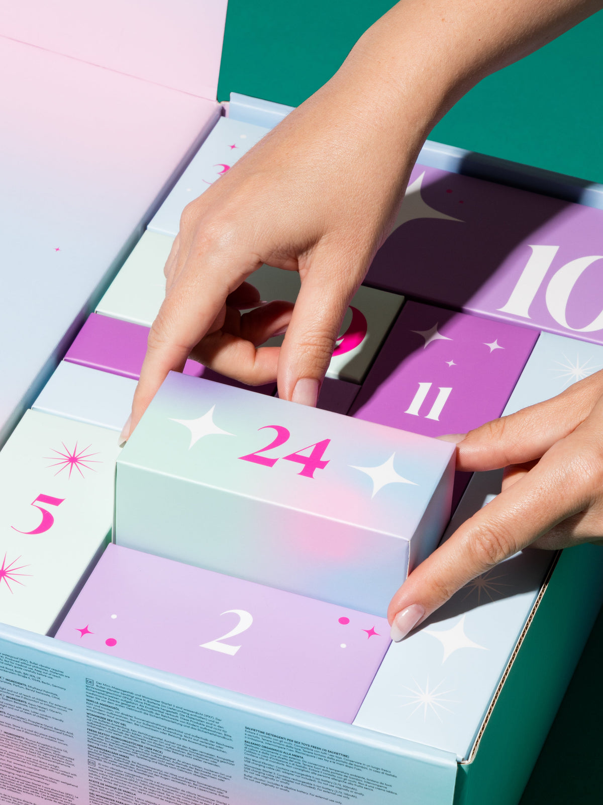 close up of hand pulling out box from advent calendar
