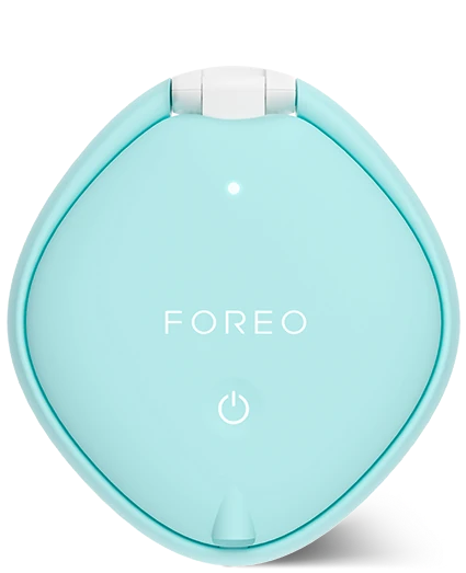 A light blue Foreo skincare device with a white hinge and white printed logo on a clean white background.