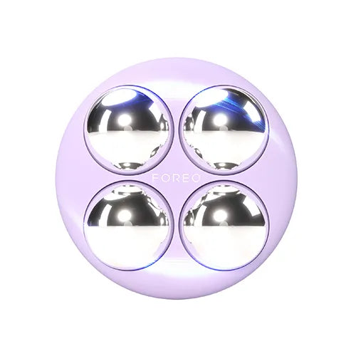 Purple round DEVICE with four metallic spheres on a white background