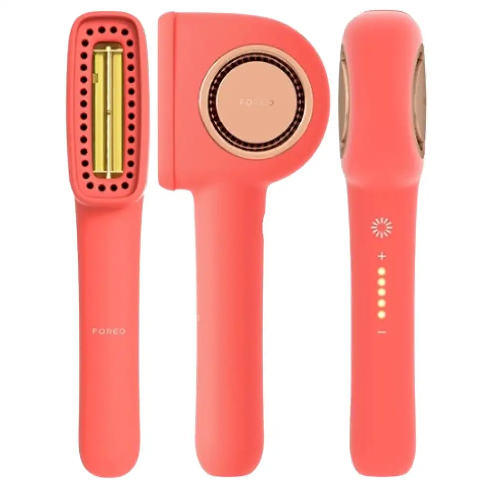Coral-coloured hair tool with gold accents on a white background