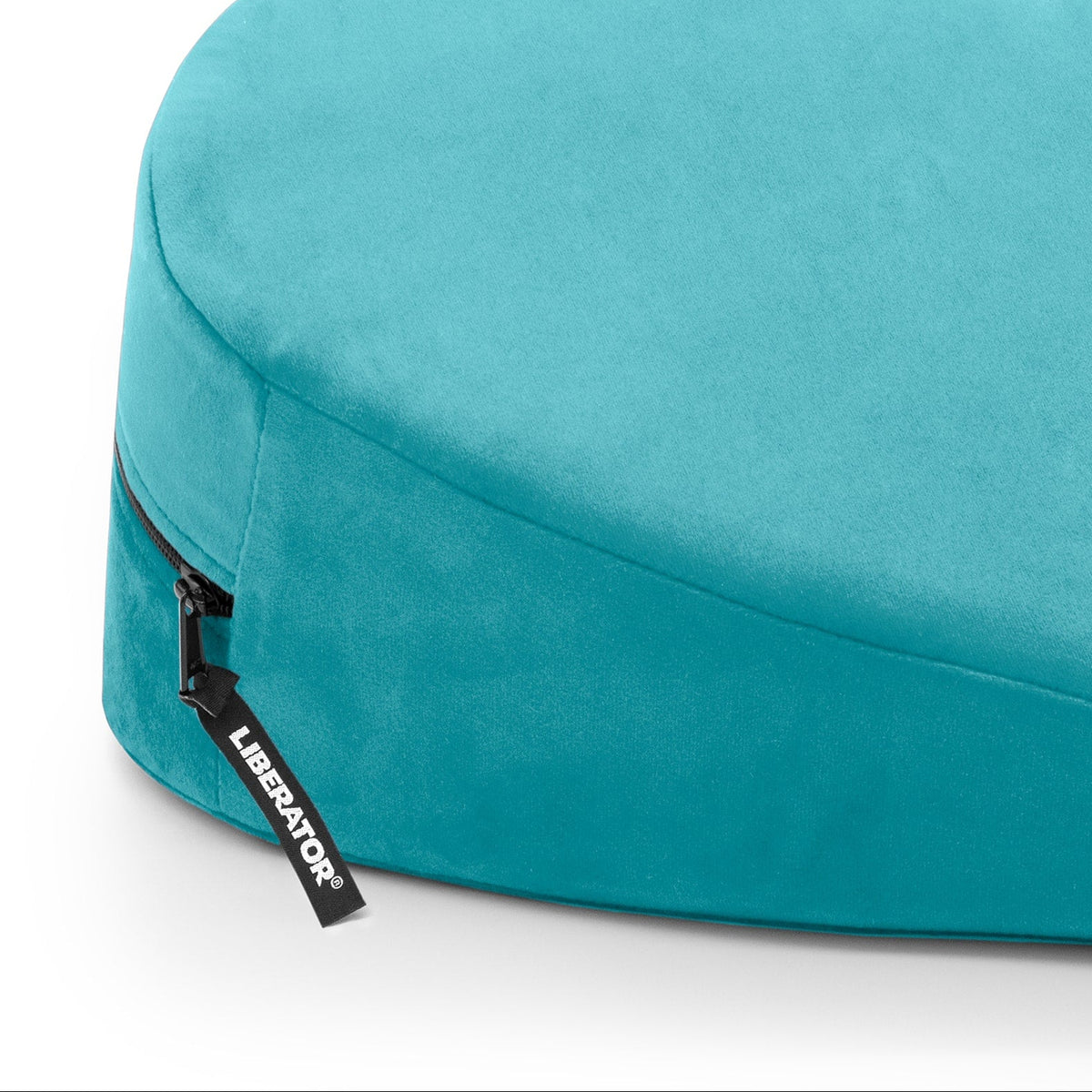 Turquoise heart-shaped pillow with a brand label on a white background