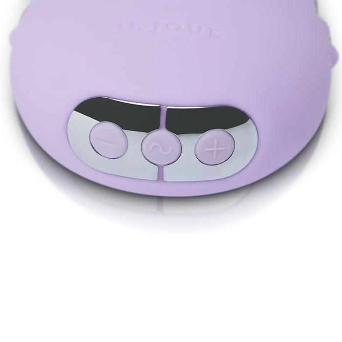 Close-up of a purple electronic device with control buttons on a white background