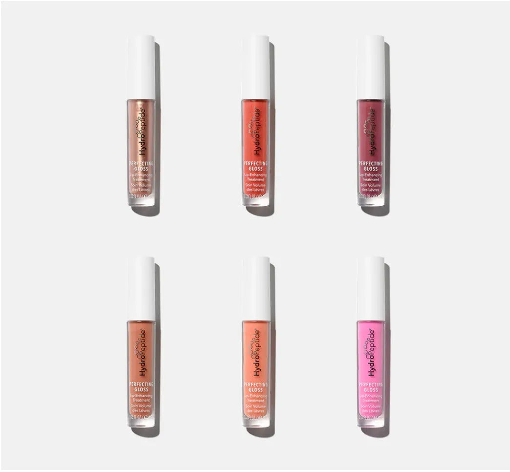 Set of six lip glosses in different shades on a white background