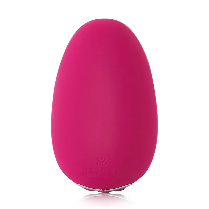A bright pink egg-shaped personal massager with a matte finish and a small silver base, shown on a clean white background with a subtle reflection.