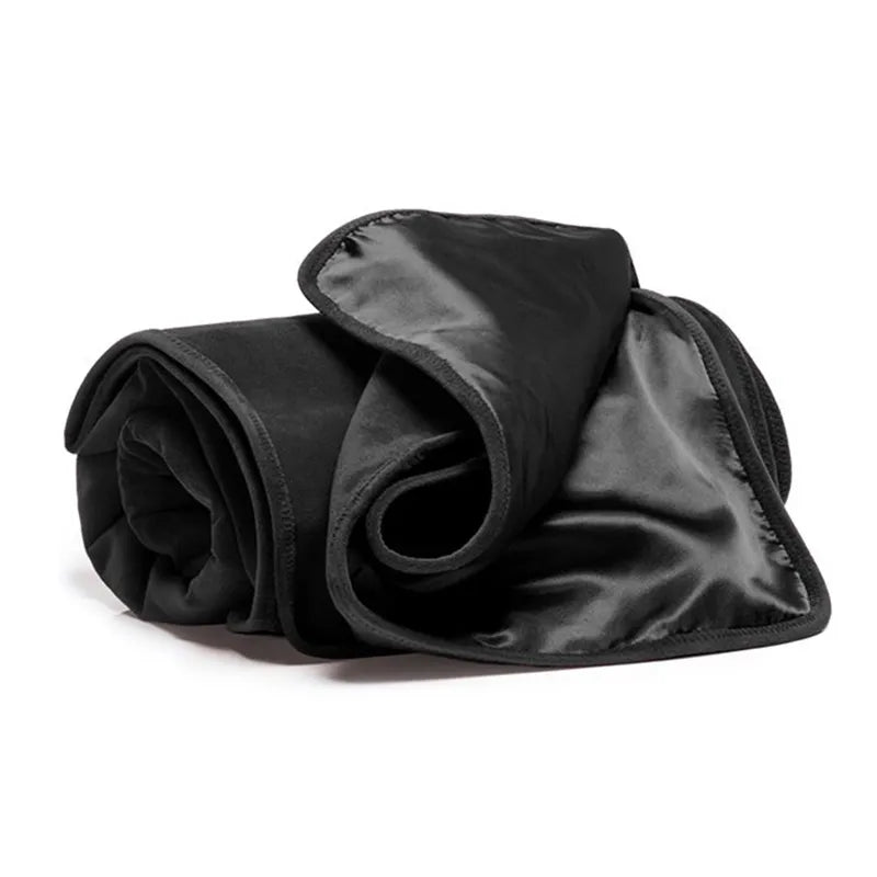 Folded black blanket on a white background