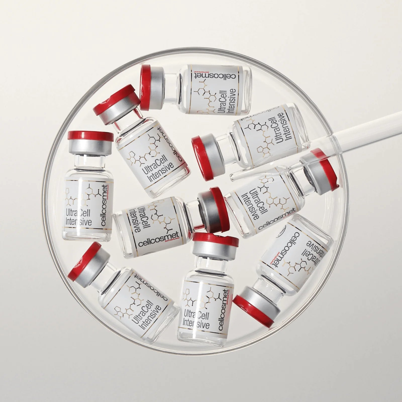 Collection of Cellcosmet vials arranged in a circular pattern on a light gray background.