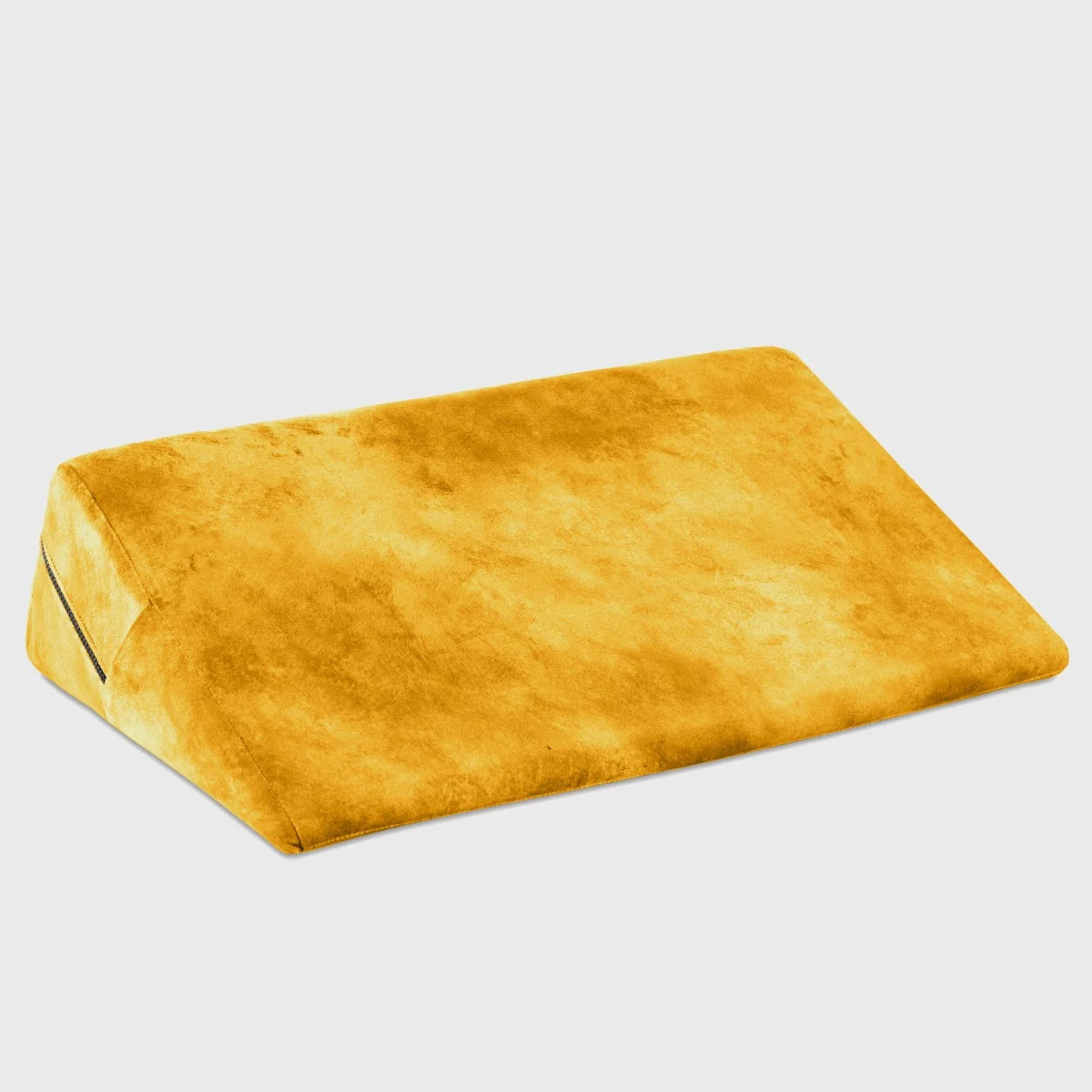 Yellow wedge pillow on a light gray background