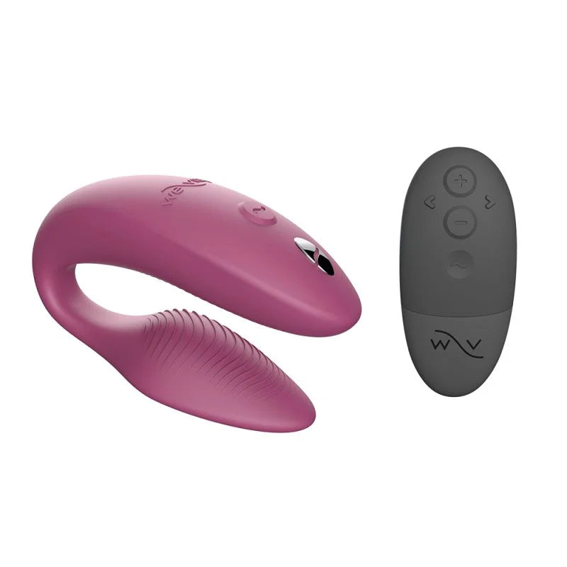 Pink and gray electronic device with remote control on a white background